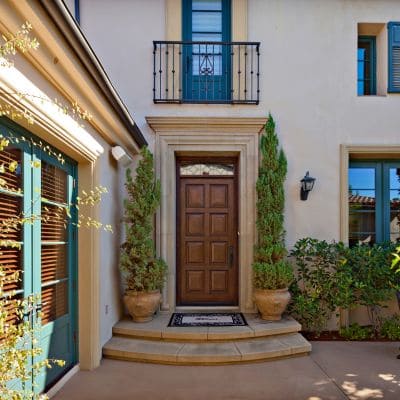 Beautiful custom home entrance with a wooden front door