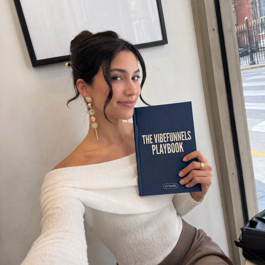 The VibeFunnels Playbook held by a reader