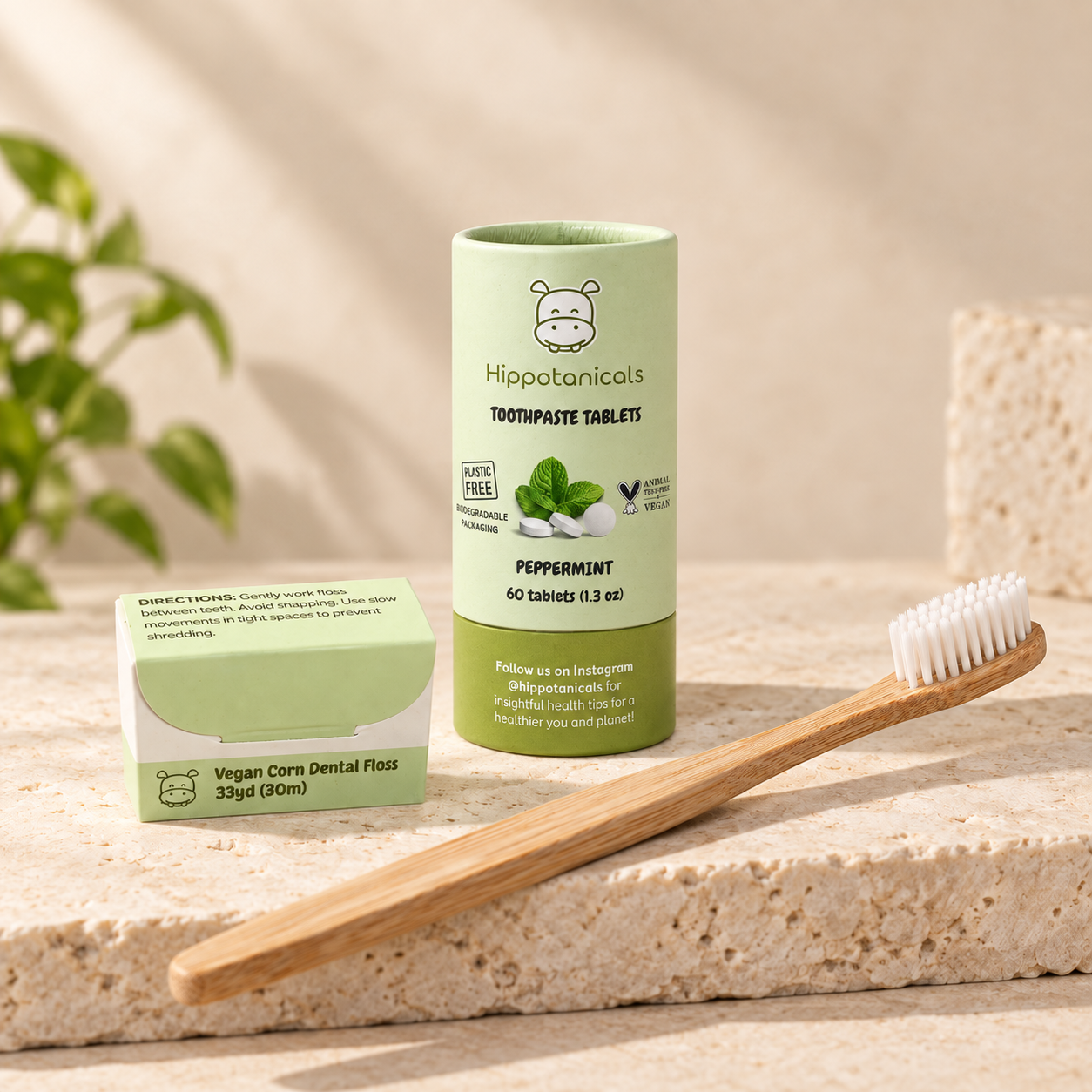 The Essential Oral Care Bundle: a Hippotanicals tube of peppermint toothpaste tablets, vegan corn dental floss and a bamboo toothbrush