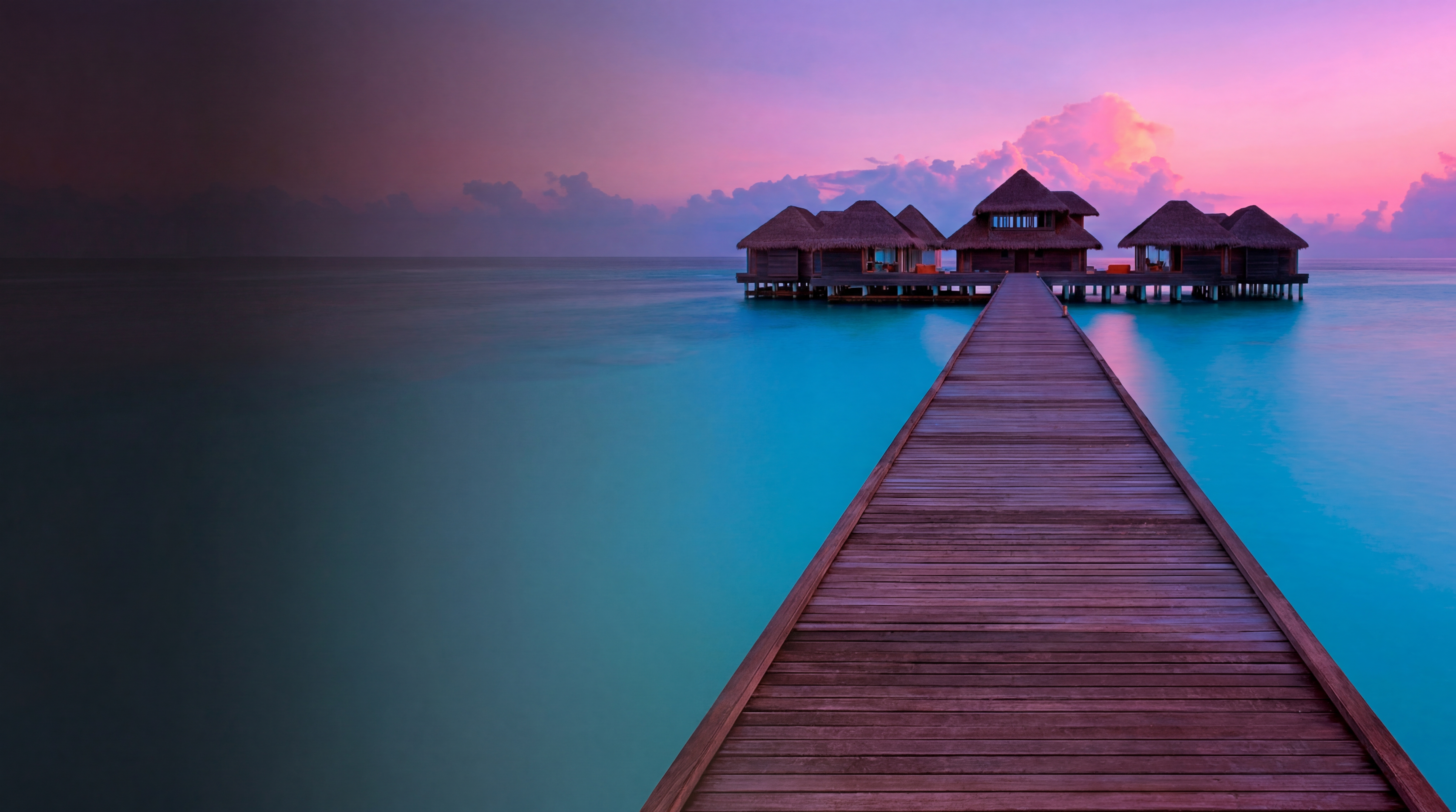 A solitary sailboat glides across glass-still water at golden hour — the unhurried luxury of well-planned travel.