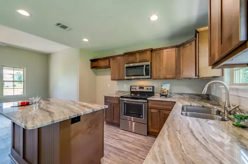 Kitchen with wood cabinets and stone countertops