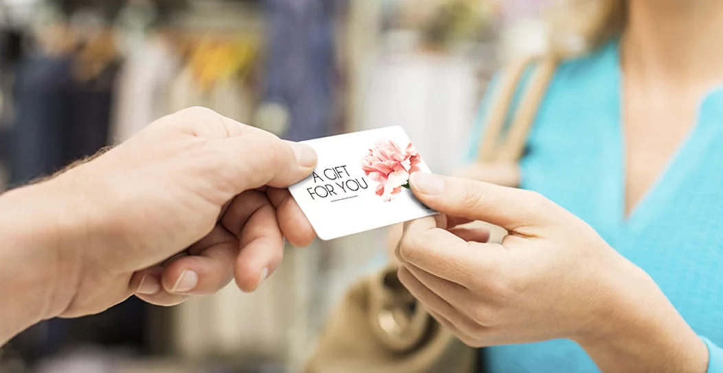 Customer receiving a gift card at a retail store