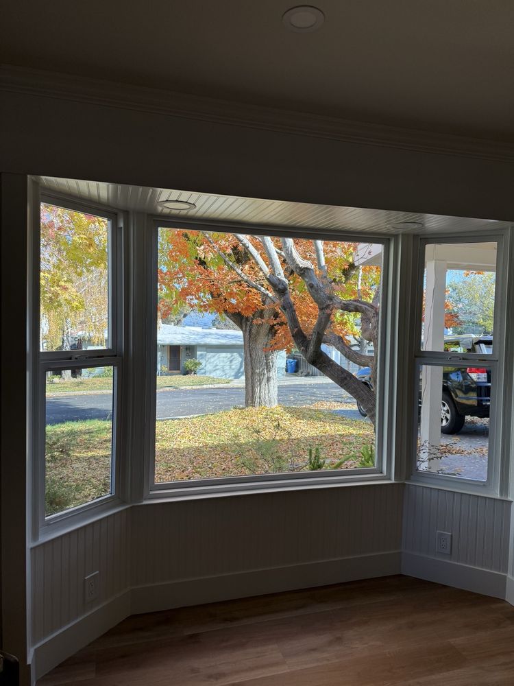 New bay window installation overlooking autumn trees