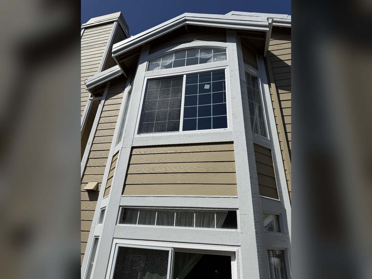 Two-story window replacement with arched transom