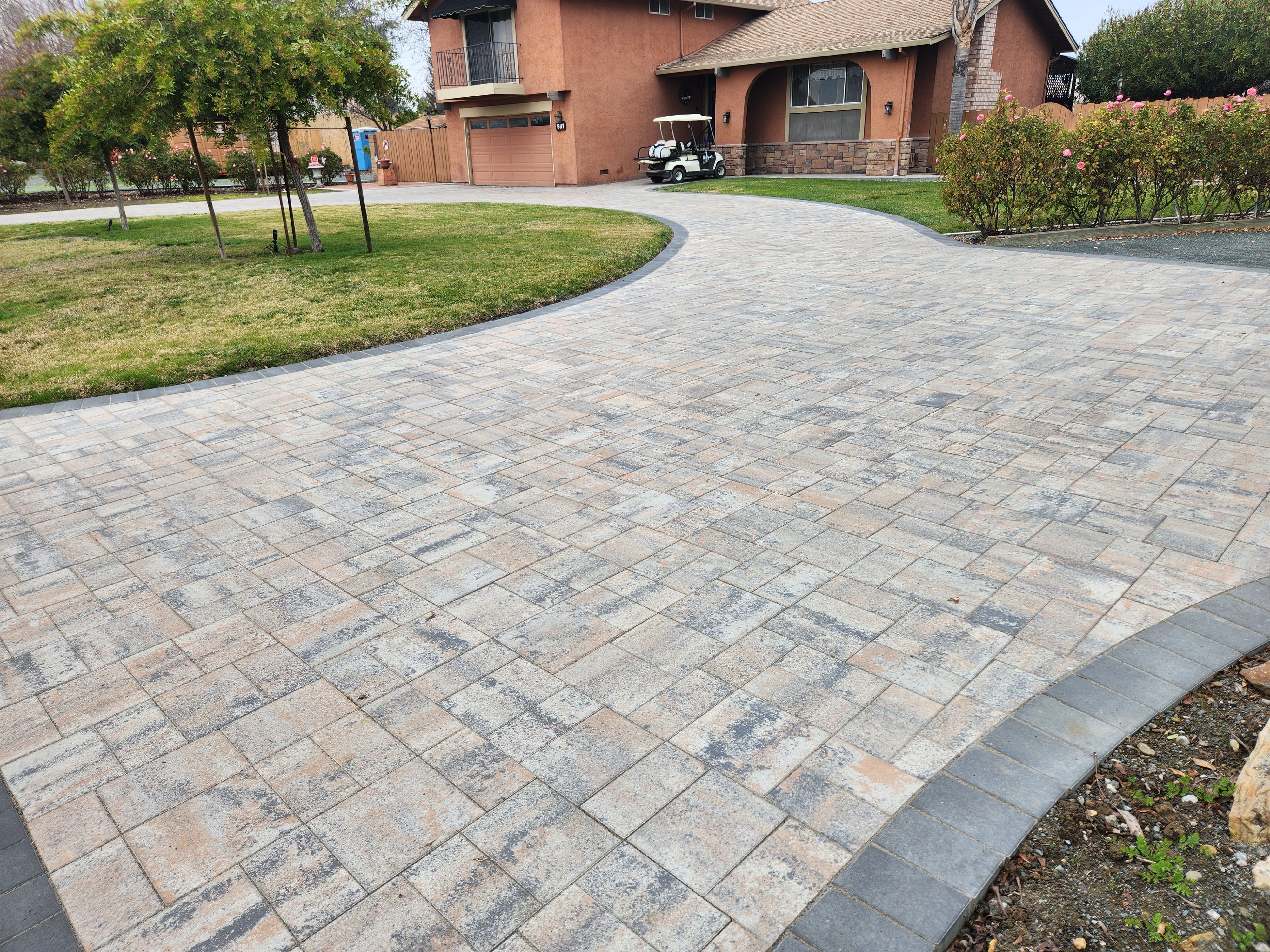 Retaining wall with tiered landscaping and paver steps in Brentwood, CA - Paradise Building Materials project