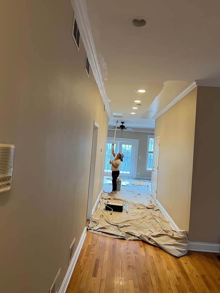 Interior hallway with a worker near the windows at the far end