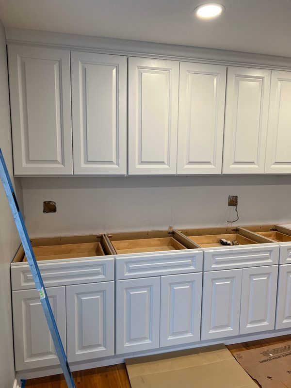 Kitchen with white cabinets and a tiled backsplash
