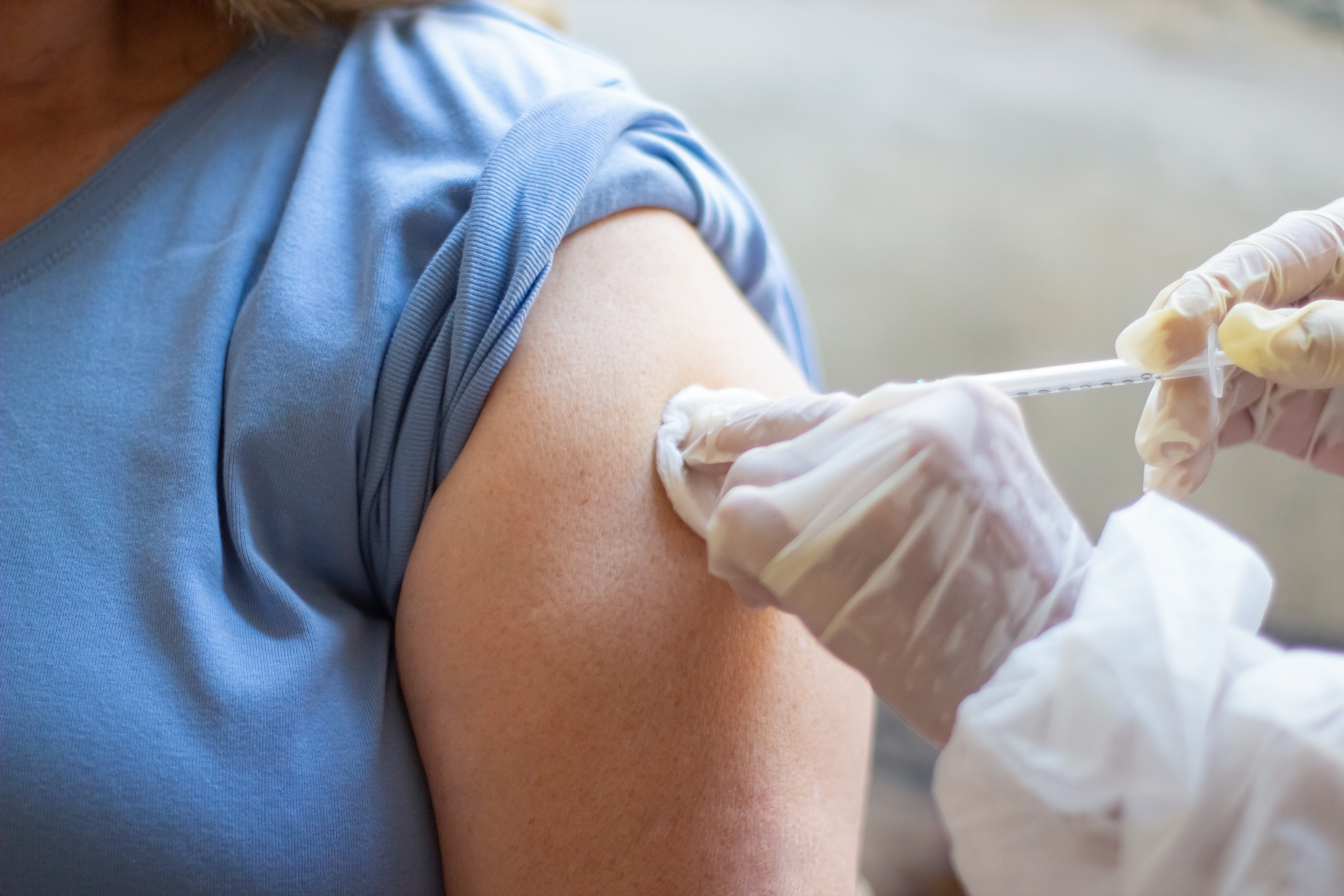 A member of the Atlantic Plaza care team helping a patient