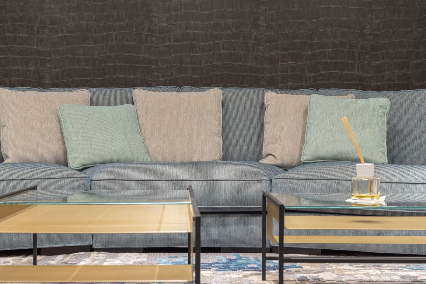 A grey fabric sofa with cushions in a bright living room
