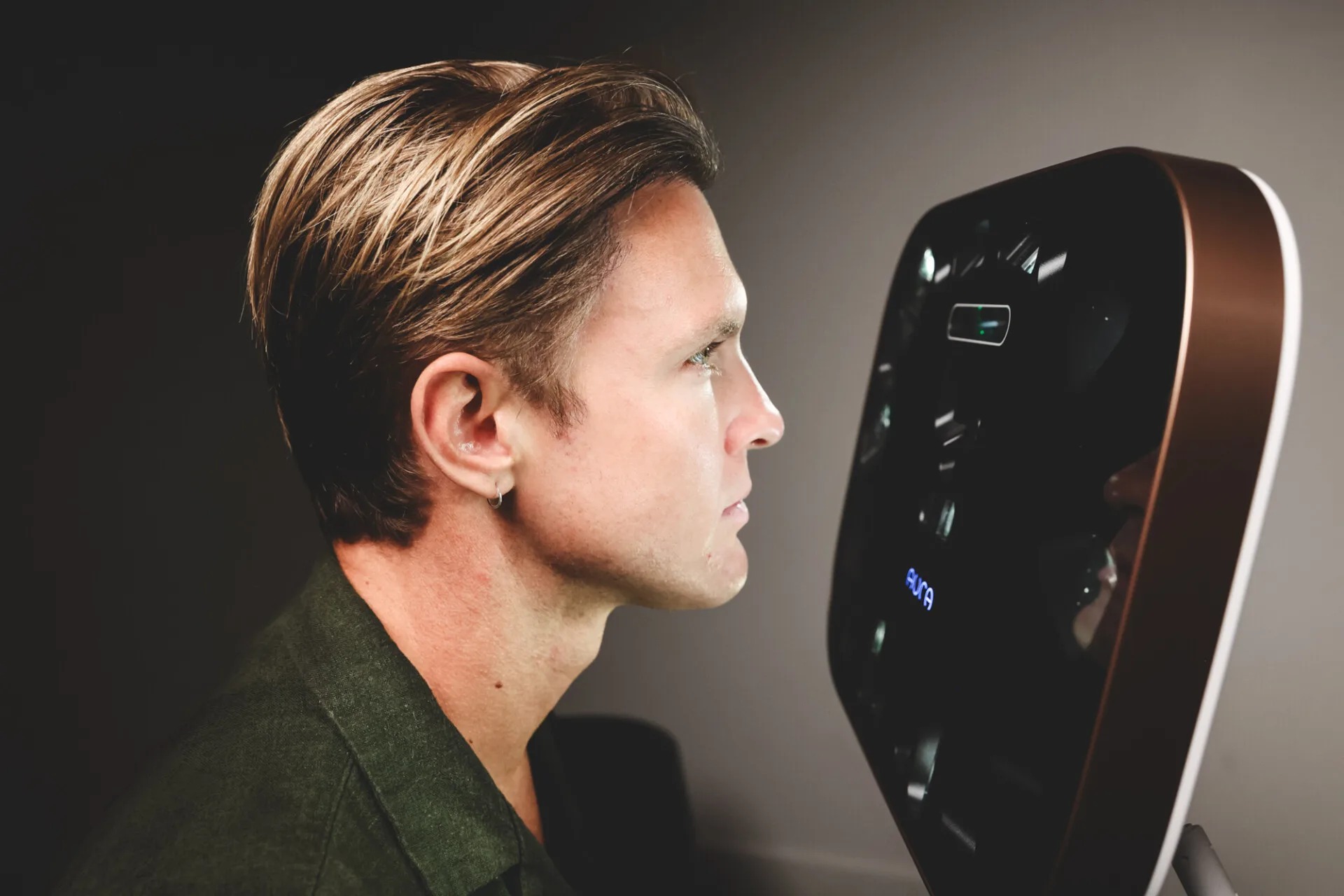 Client receiving a 3D Aura Reality skin scan in a medical spa setting