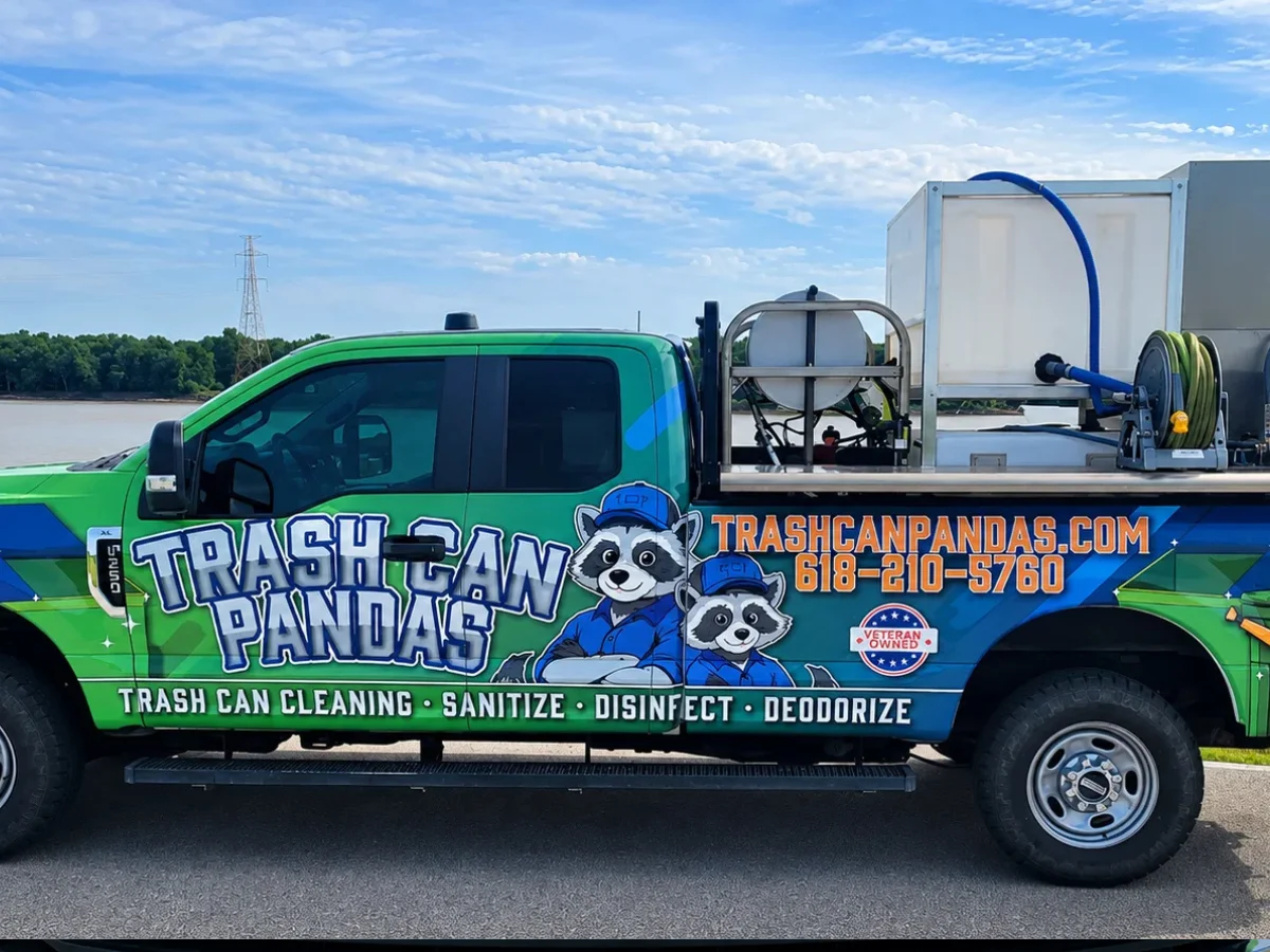 A bright green "Trash Can Pandas" cleaning truck with raccoon mascots, equipment, and contact info on the side, parked outdoors.