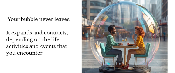Couple sitting outdoors at table surrounded by iridescent bubble