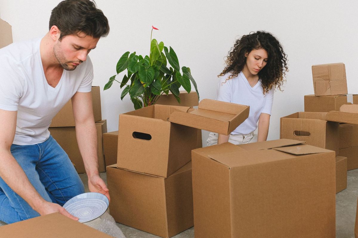 A couple unpacking boxes in their new home