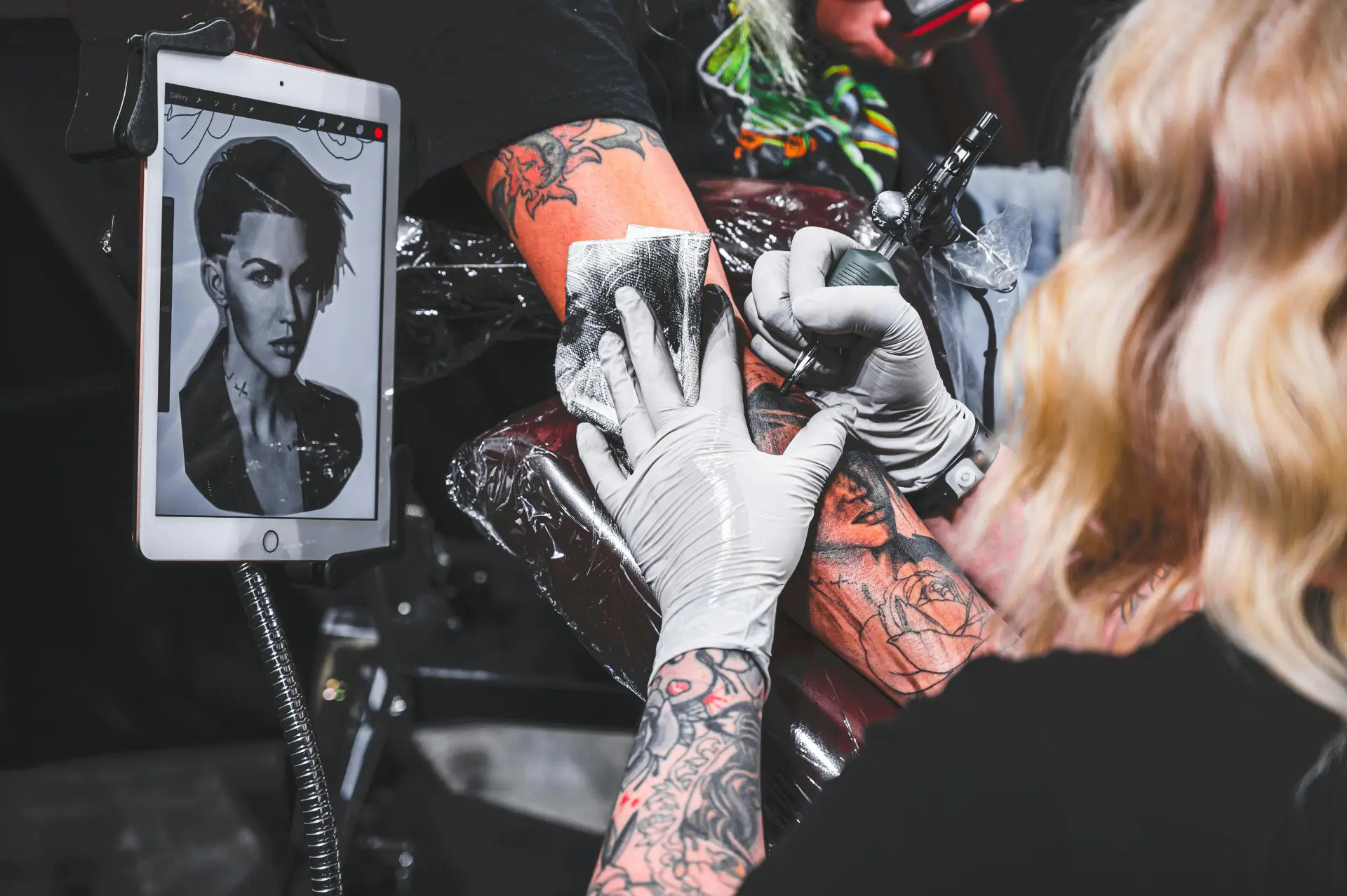 Ink Different tattoo artist working with a client