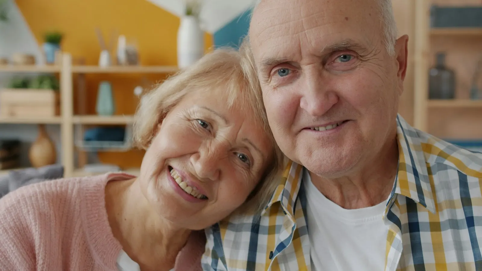 Smiling retired couple cheek to cheek