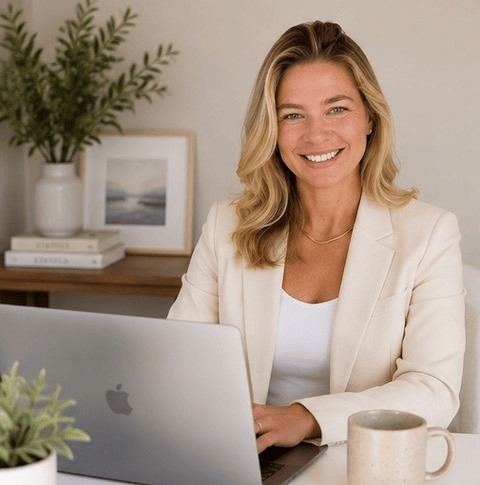 Woman smiling while talking on the phone at her desk