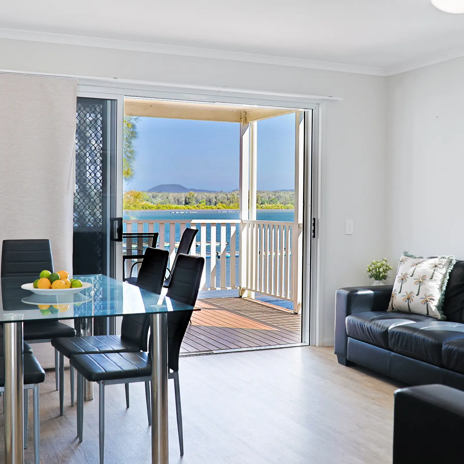 Riverfront cabin dining area with river views, Nambucca Heads
