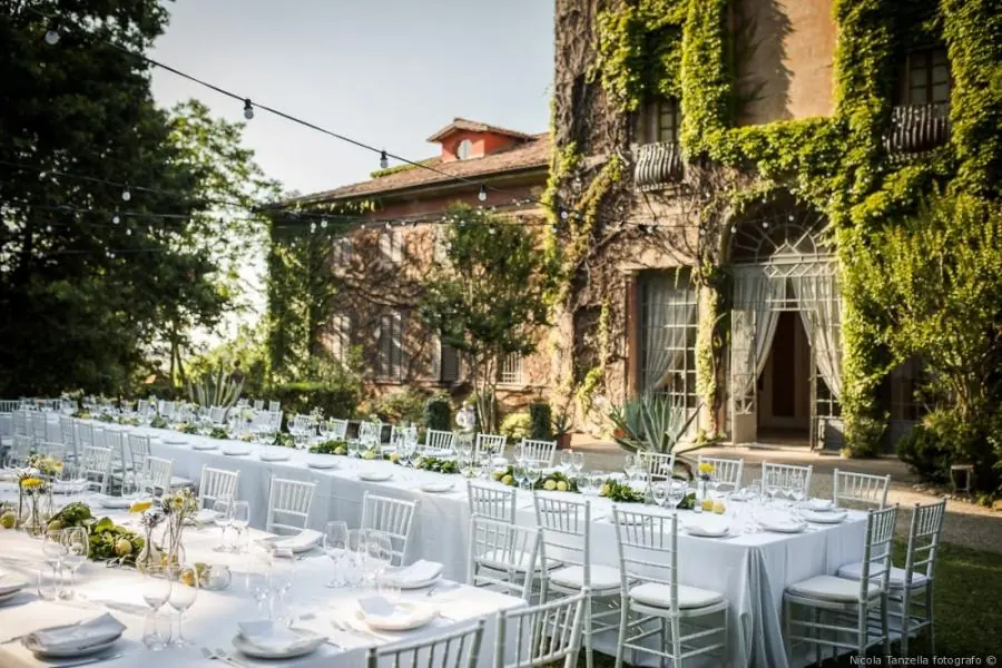 A historic Italian villa at golden hour, with a garden terrace ready for a wedding