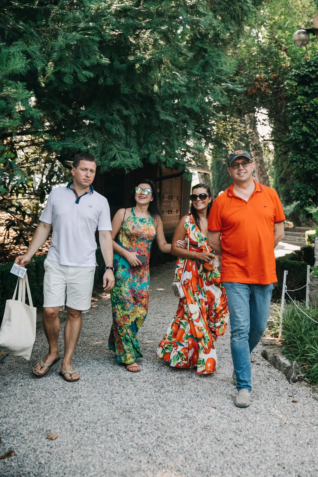 Wedding guests sharing a sunset tasting on a terrace in Italy the day before the wedding