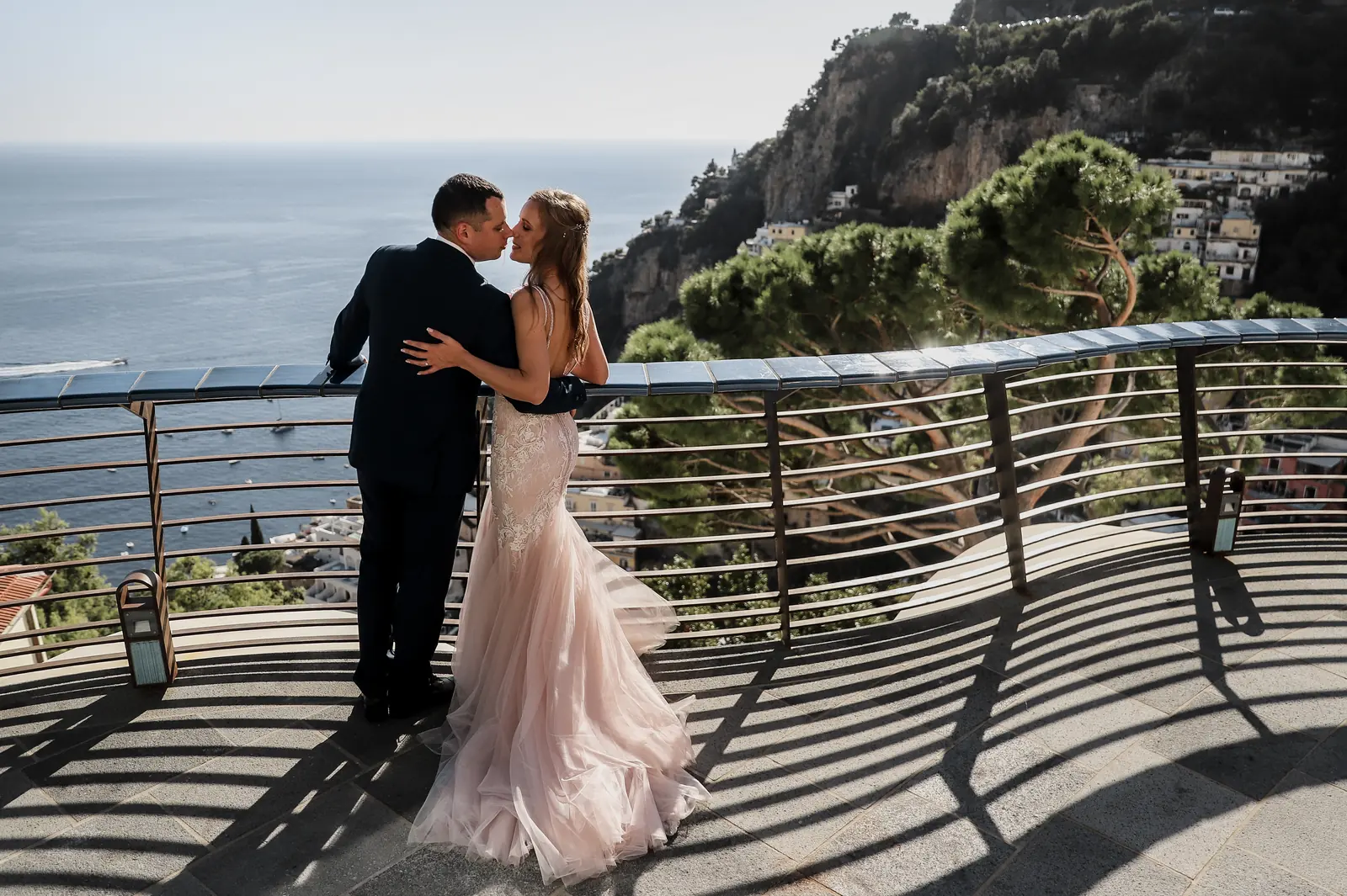 A couple reviewing their wedding planning notes at a table on a terrace in Italy