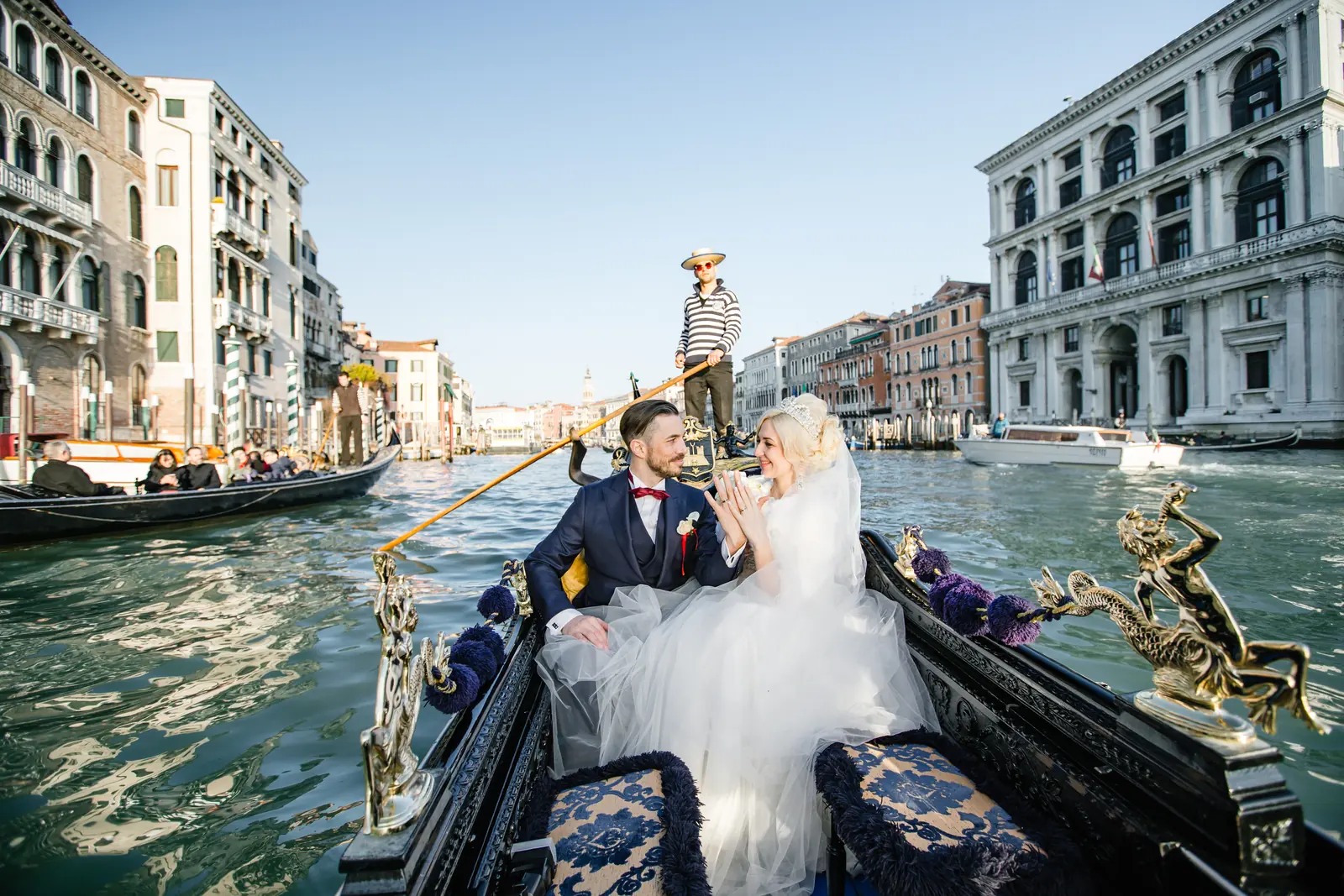 Couple planning their Italian wedding at a table with notes and a view over an Italian landscape
