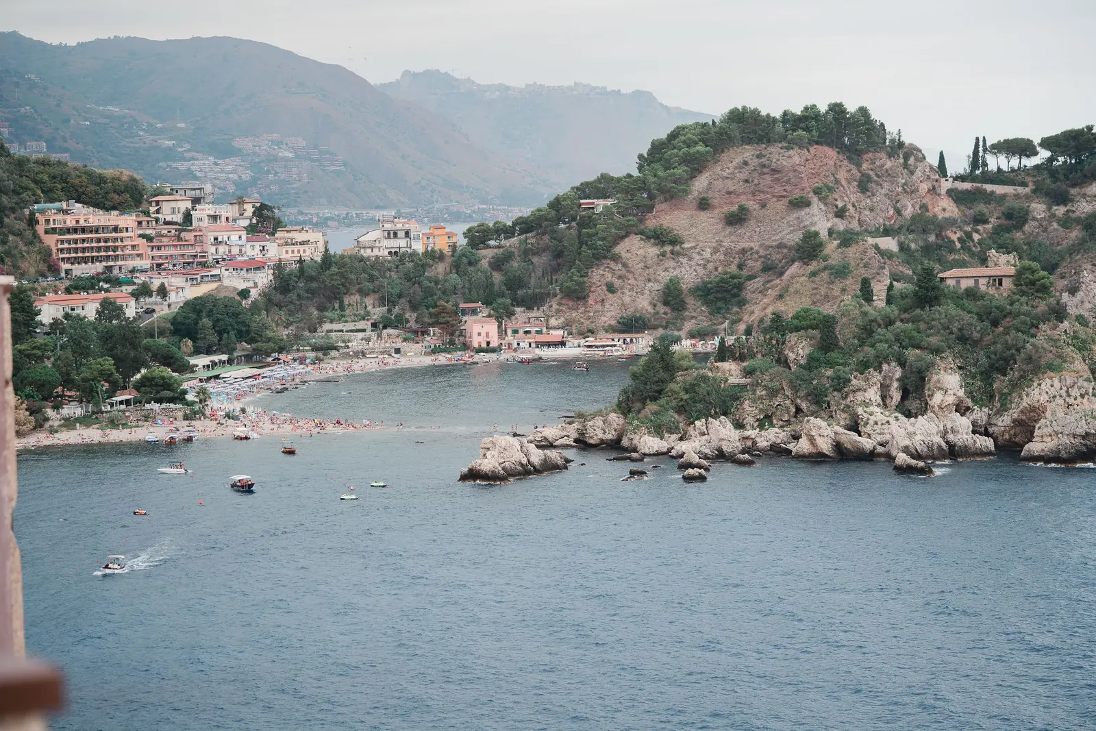 A wedding ceremony set-up in Sicily with flowers framing a view of the Mediterranean