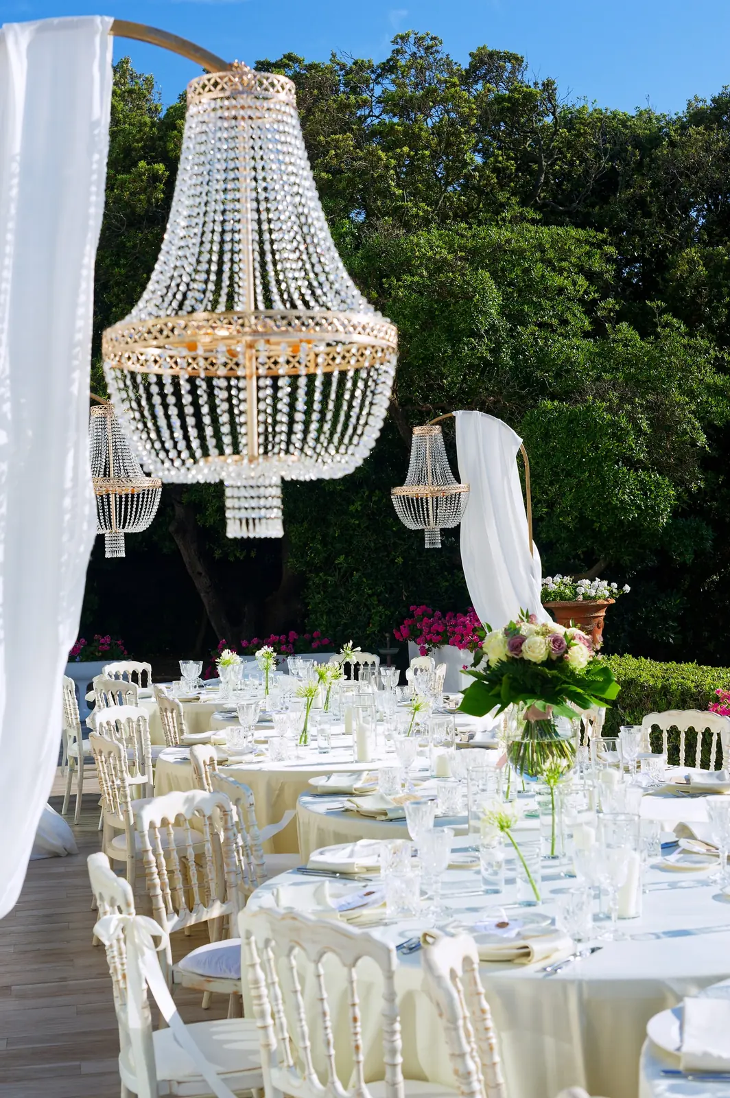 Golden late-afternoon light over the Tuscan hills, with a wedding table set among the vineyards