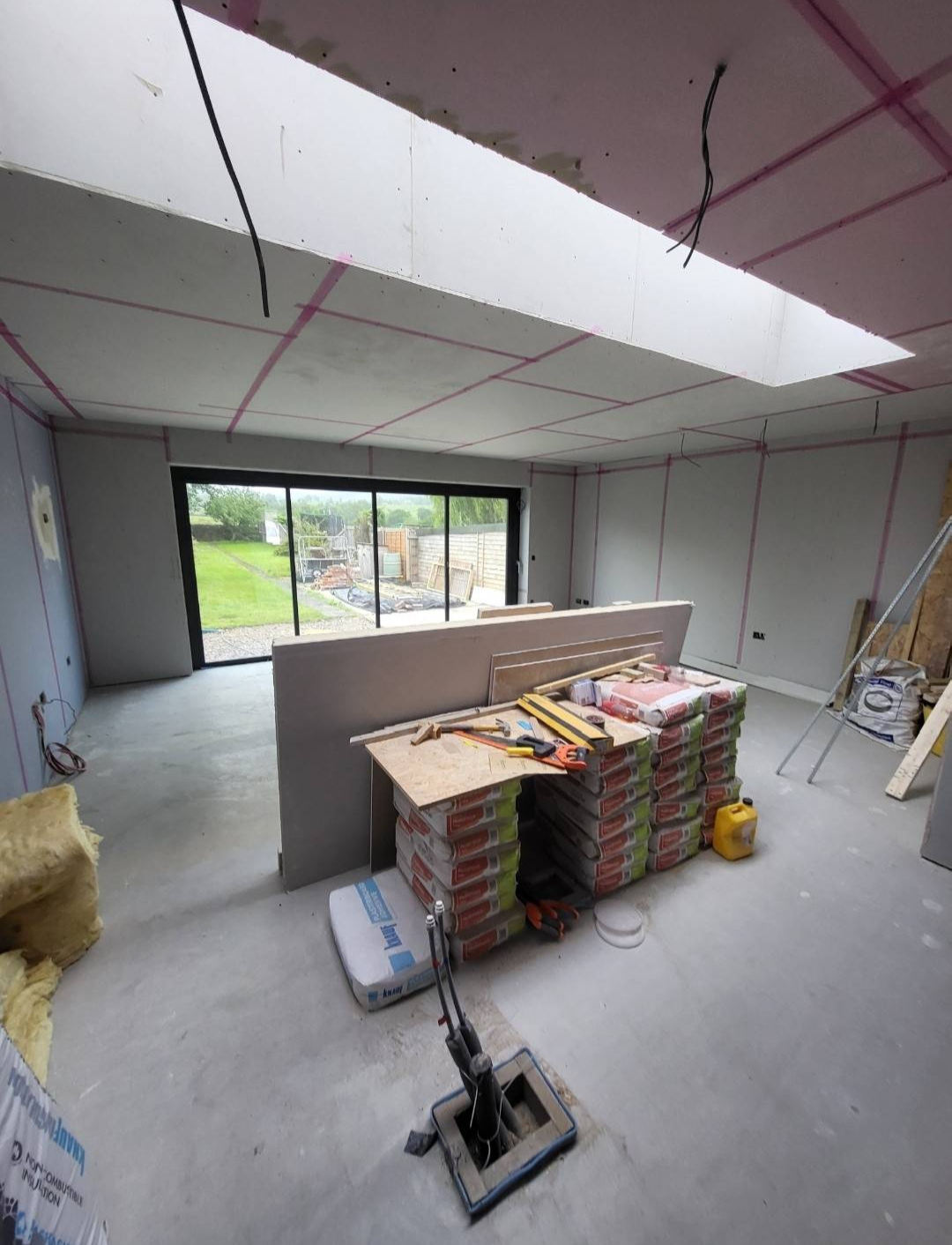 Plasterboard installation across a ceiling and walls