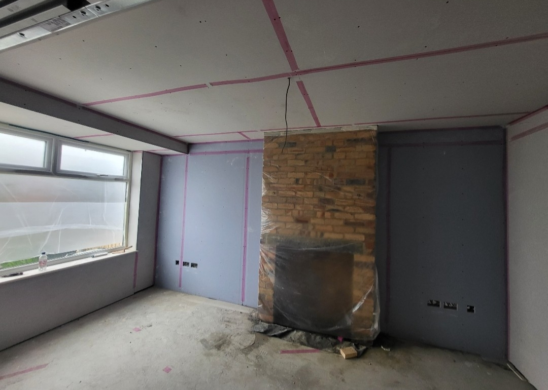 Large plastered open-plan interior finished to a smooth standard