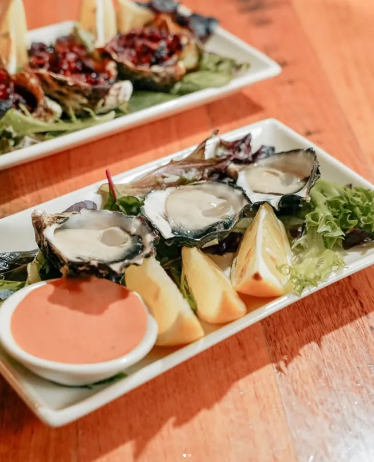 Fresh oysters with lemon and Kilpatrick oysters behind