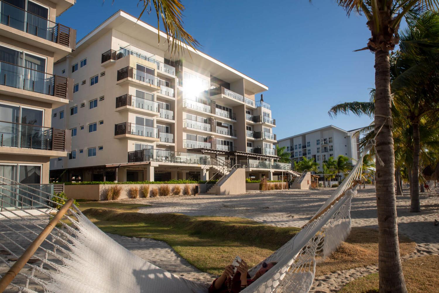 Beachfront residences at Playa Caracol with a hammock on the sand at golden hour