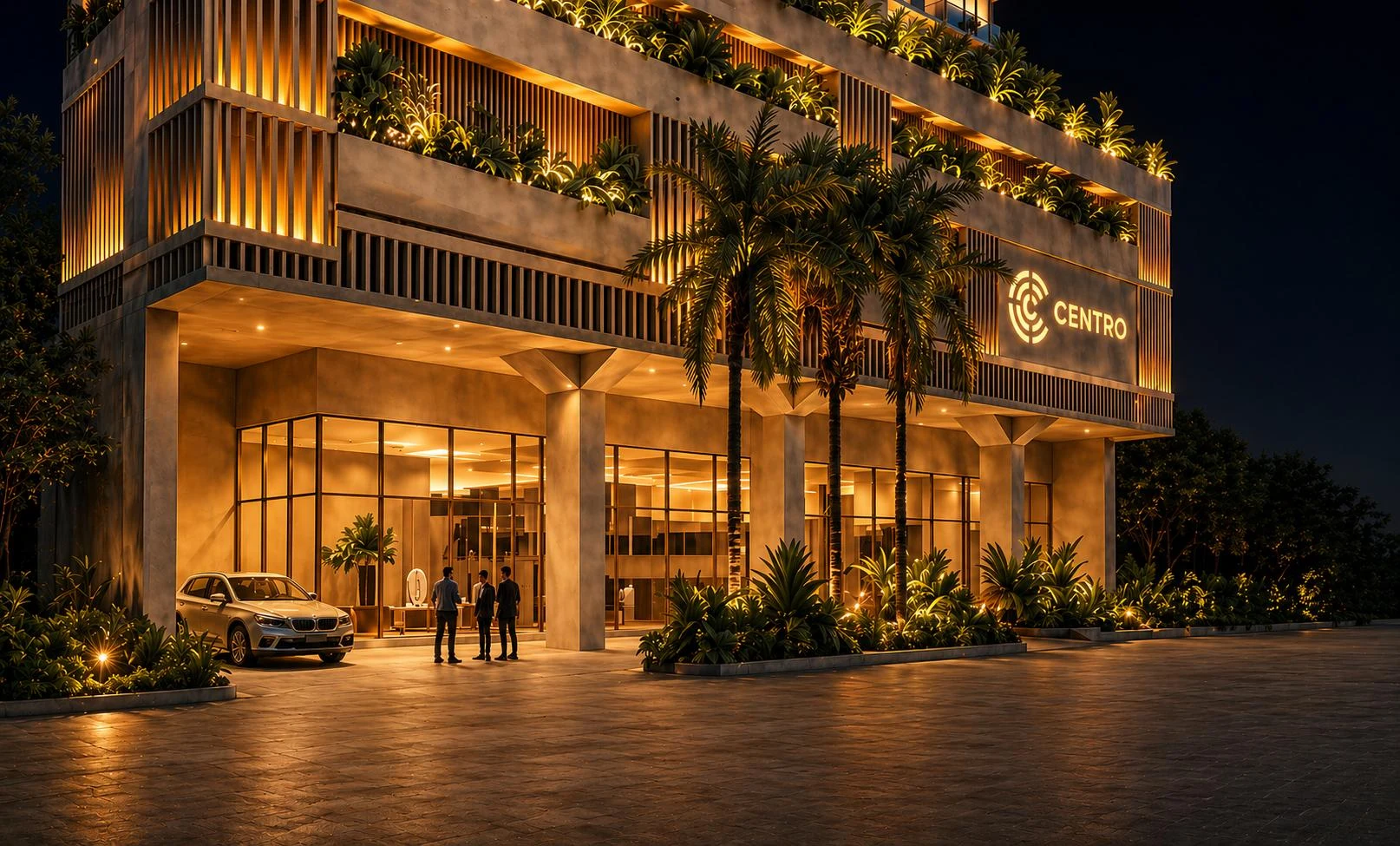 Centro’s illuminated entrance and landscaped podium at night