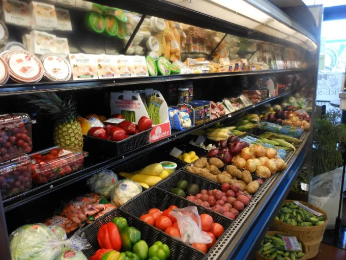 The produce and refrigerated case at Jordan Meats & Deli, stocked with fruit and vegetables