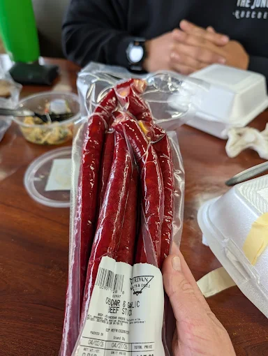 A labeled bag of cheddar and garlic snack sticks made at Jordan Meats & Deli