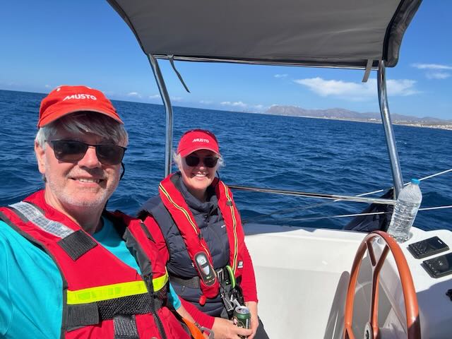 Wilhelm and a crew member at the helm, sailing the Mediterranean crossing to Mallorca