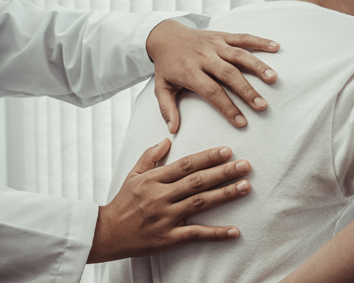Clinician assessing a chronic back-pain patient