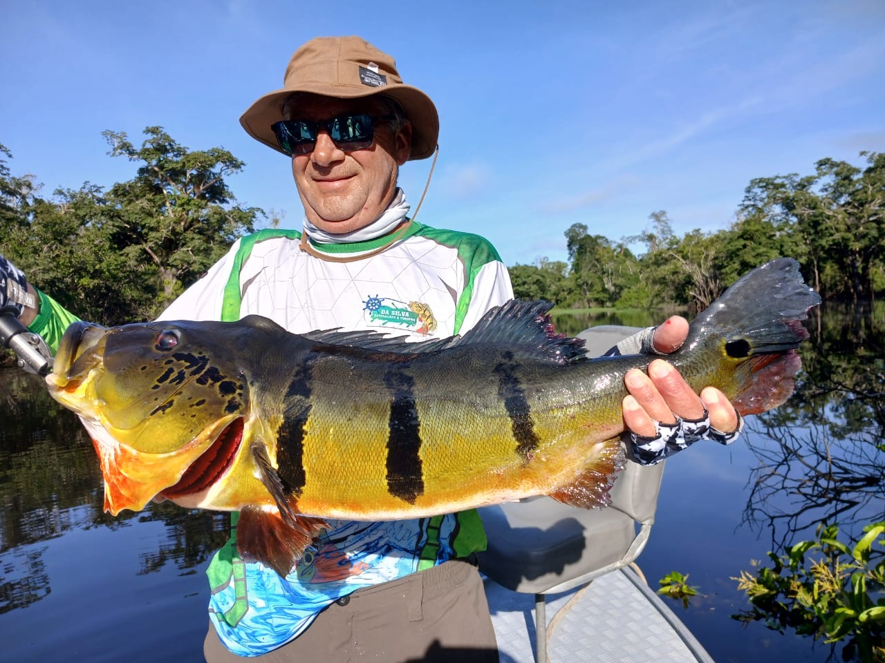 Fisherman holding peacock bass