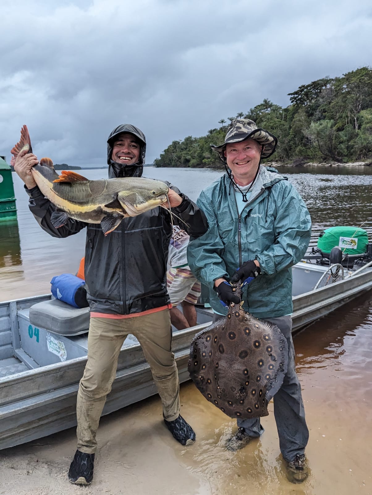 Two anglers holding their catches