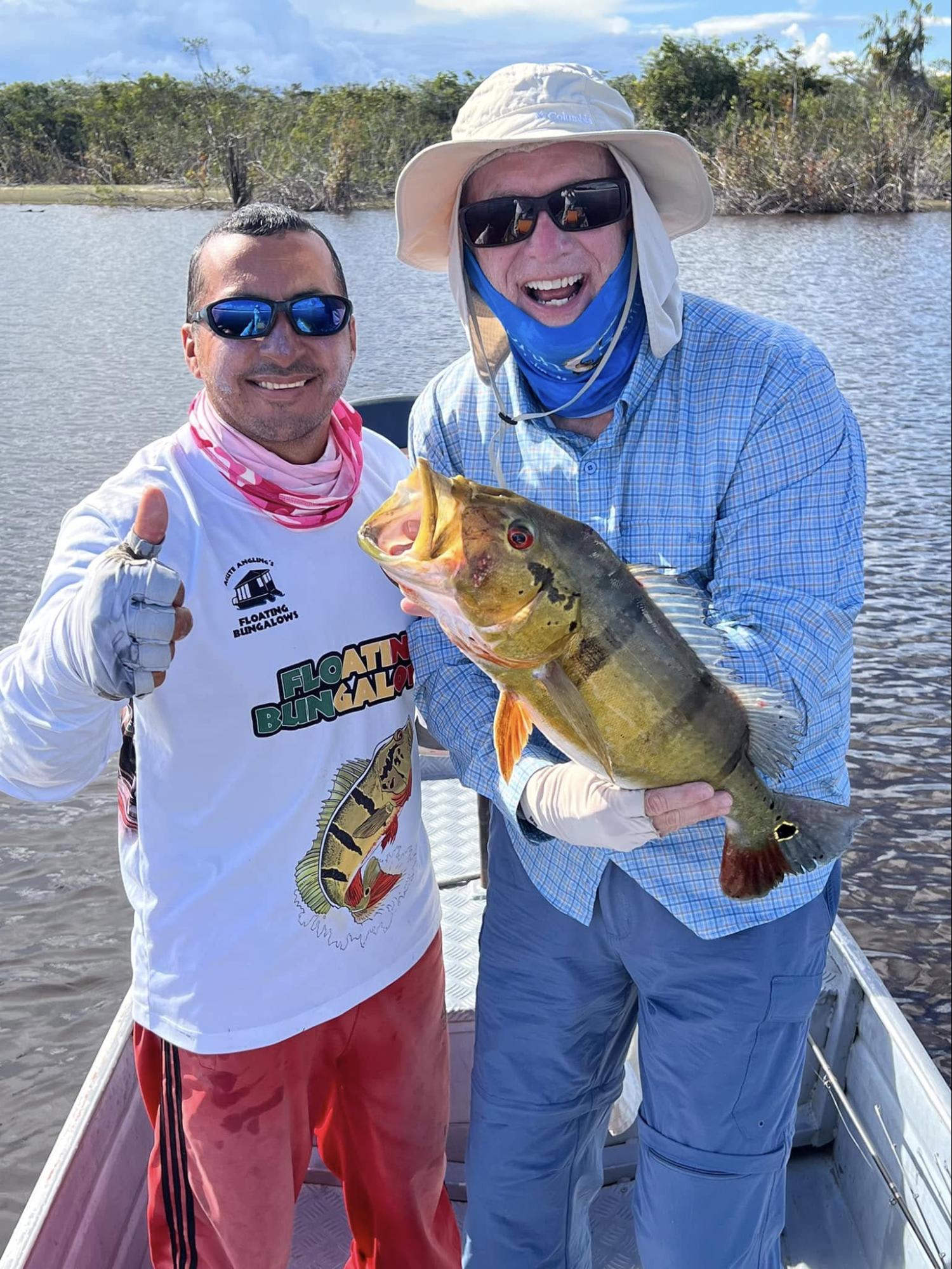 acute angling guide and client with peacock bass