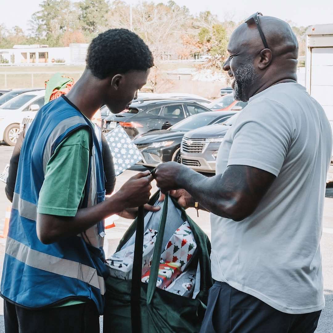 Giving Hope team serving a family with wrapped gifts