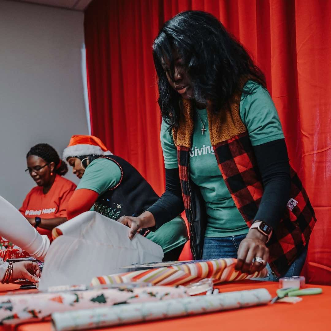 Giving Hope volunteers wrapping Christmas gifts