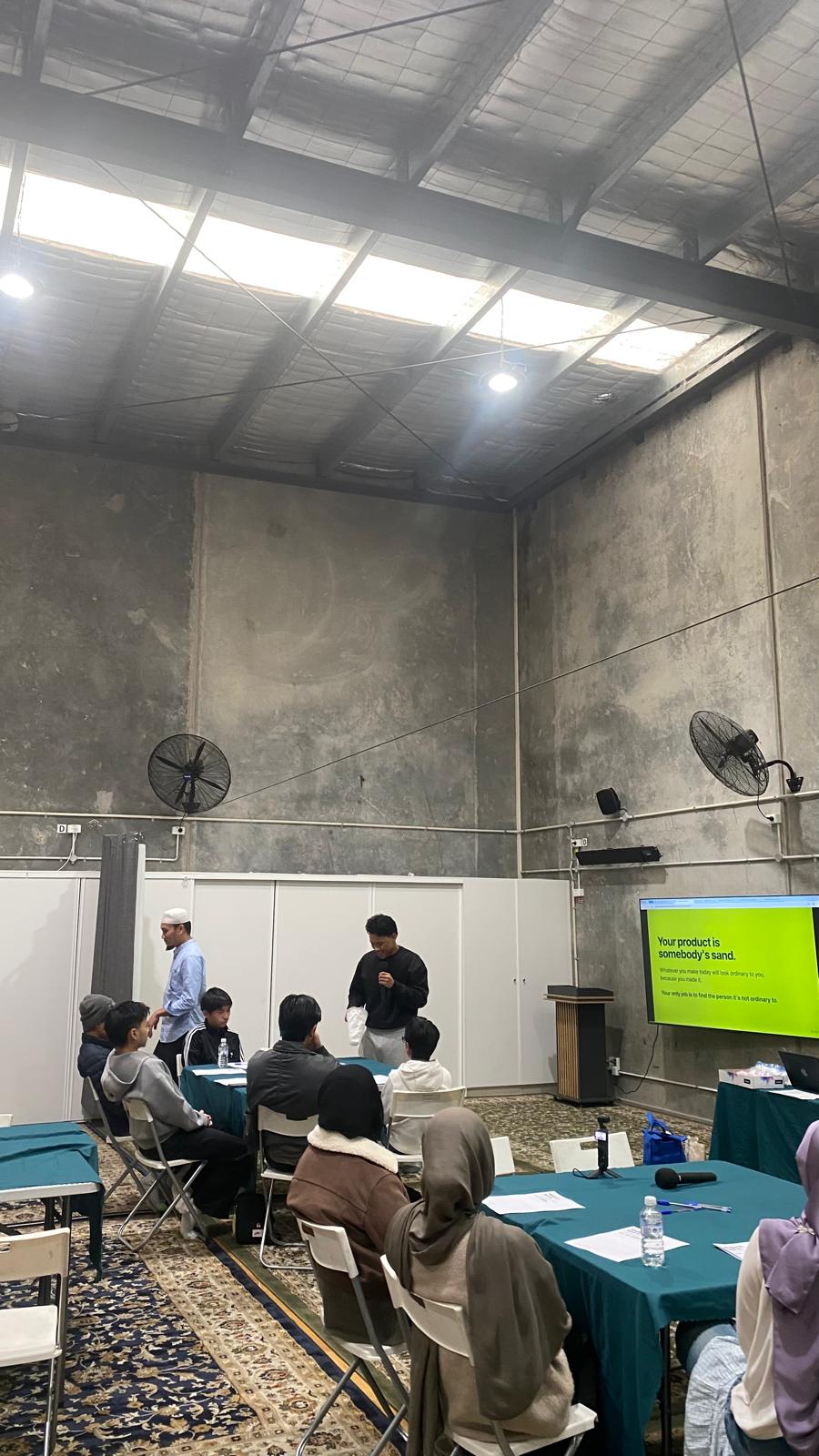 A facilitator presenting to the group at the workshop