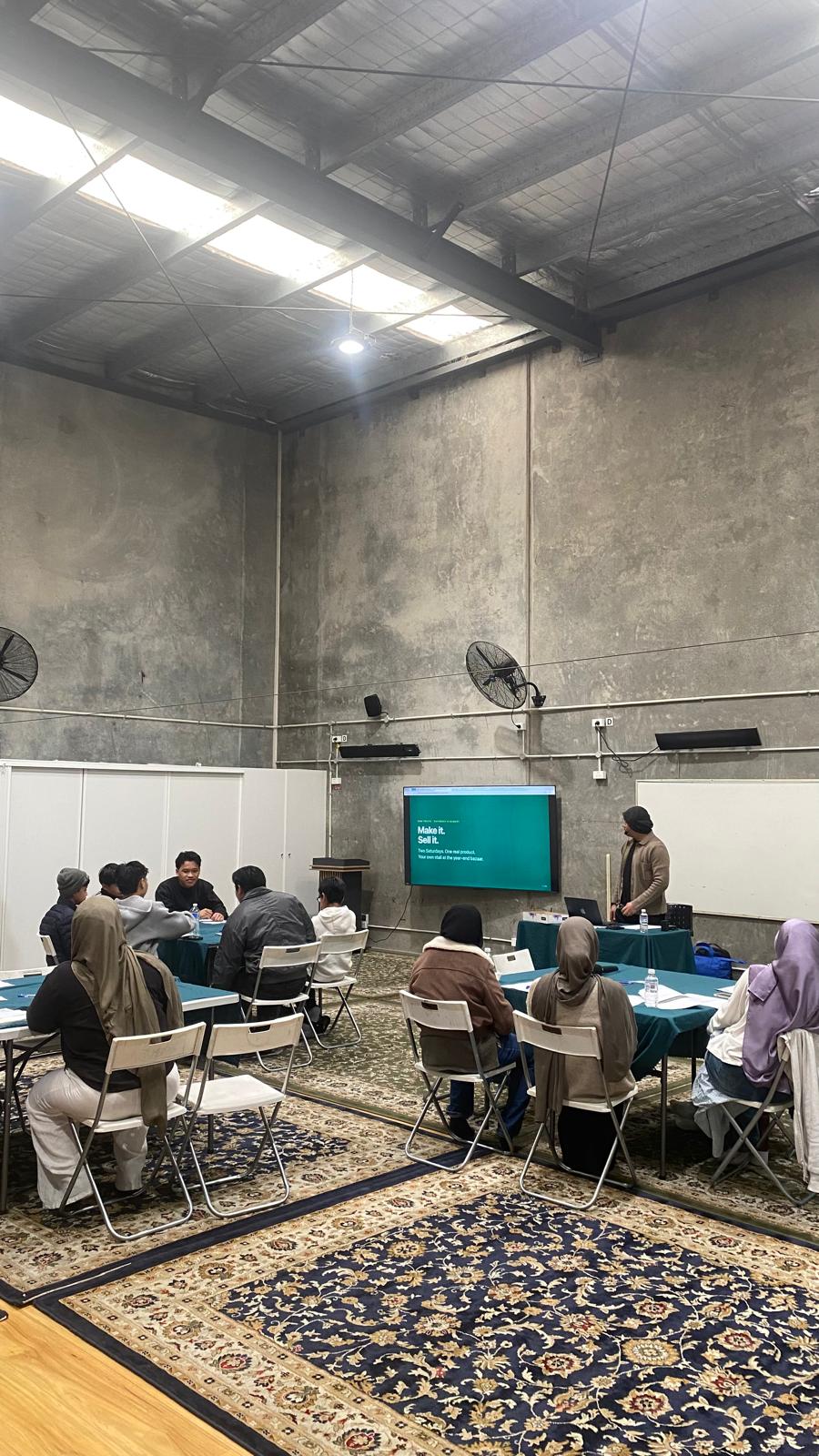 Participants seated at tables during the Make it, Sell it workshop