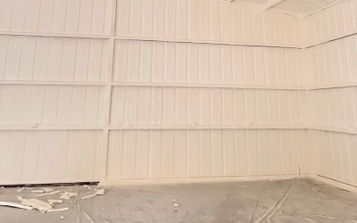 Closed cell spray foam insulation sealing metal walls for energy savings in Texas buildings