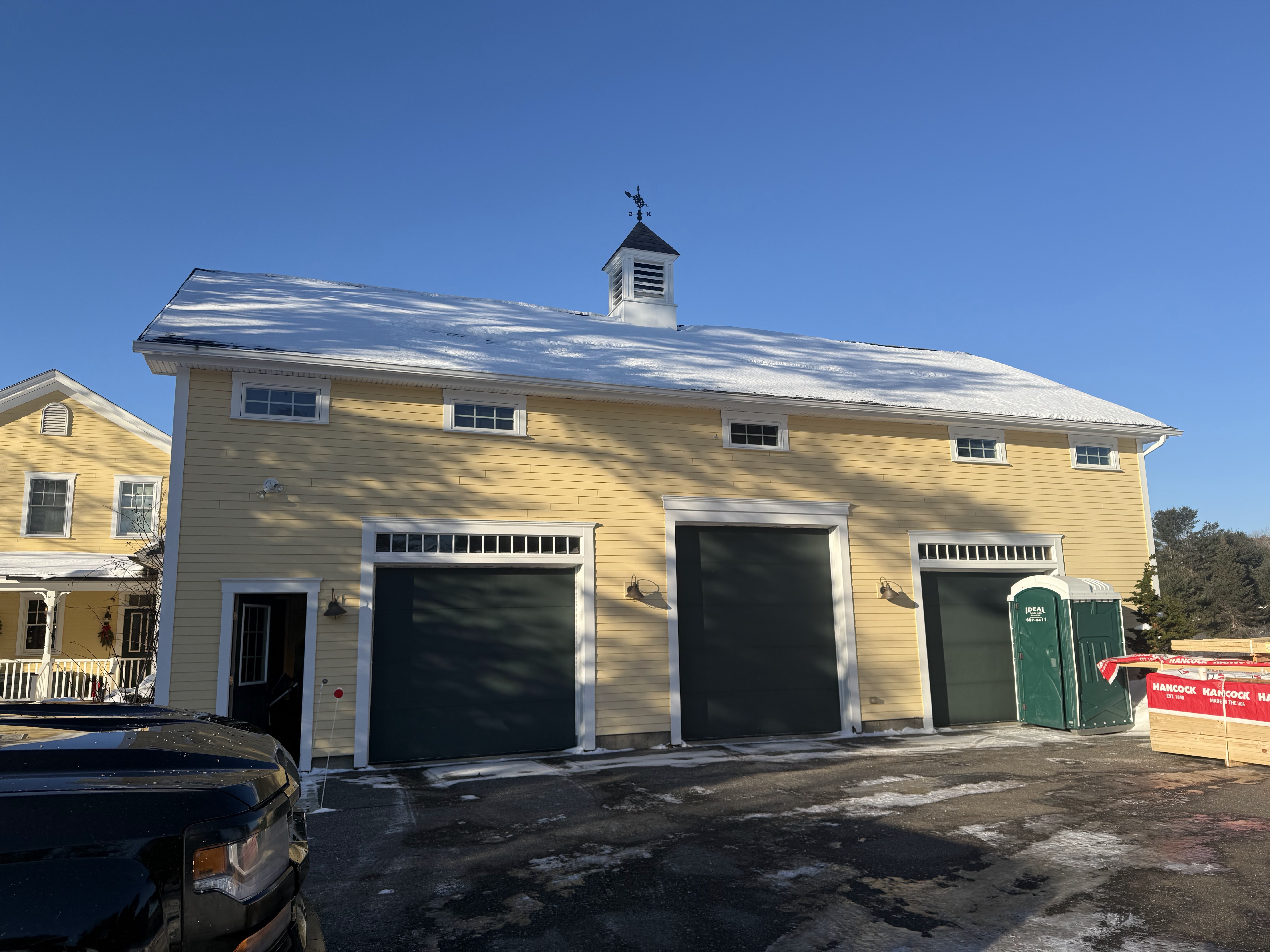 Three-bay custom garage built to complement a New England home