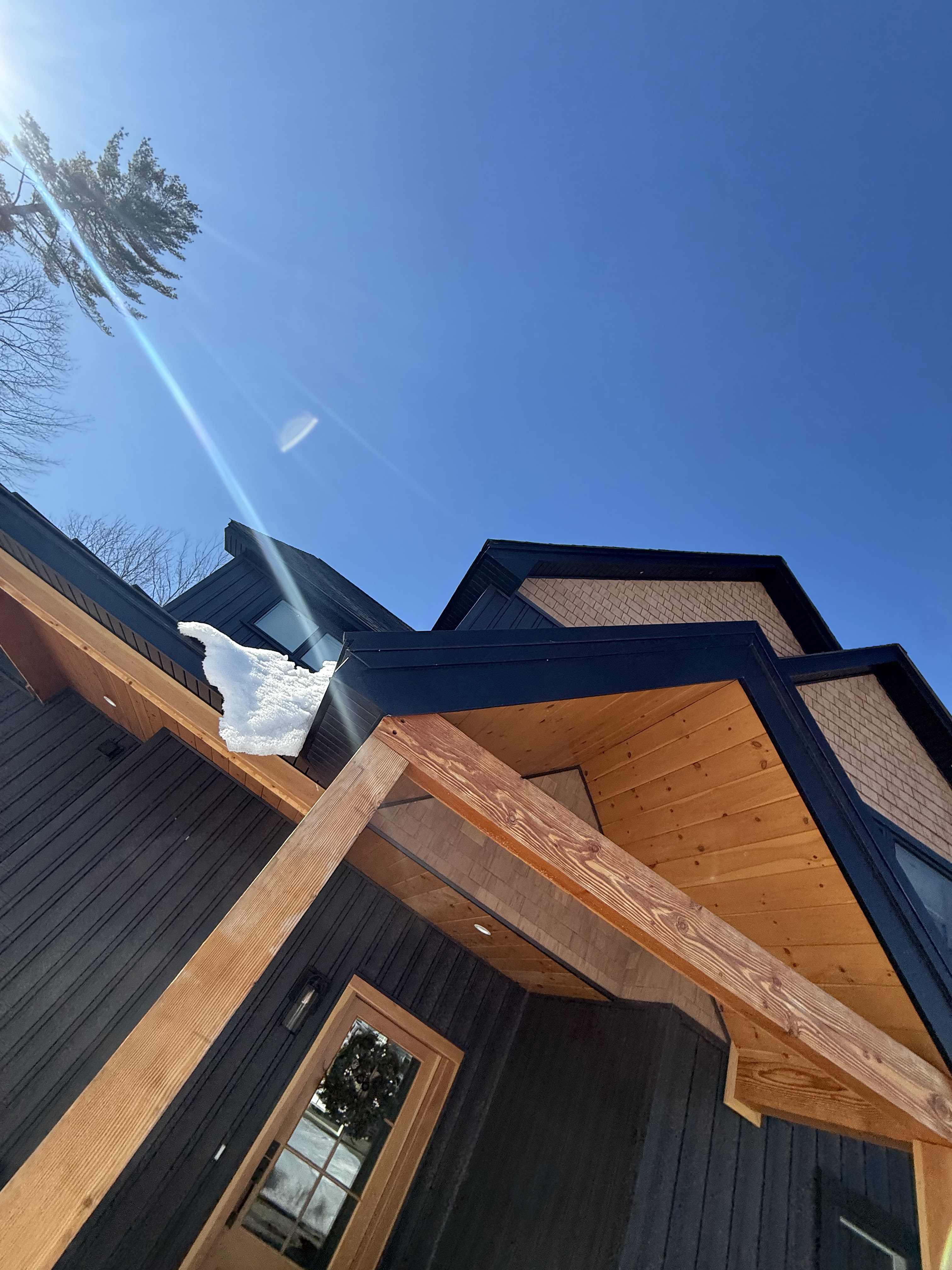 Timber entry and cedar soffit detail on a custom home
