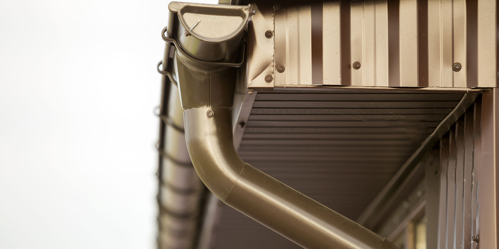 Crew installing seamless gutters for clean lines and fewer leaks.