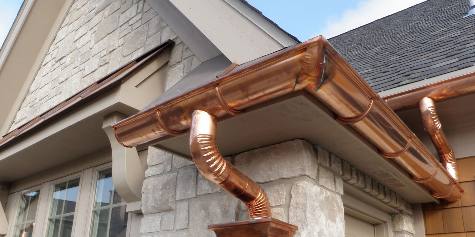 Gutter Services inspection on a home exterior before rainfall.