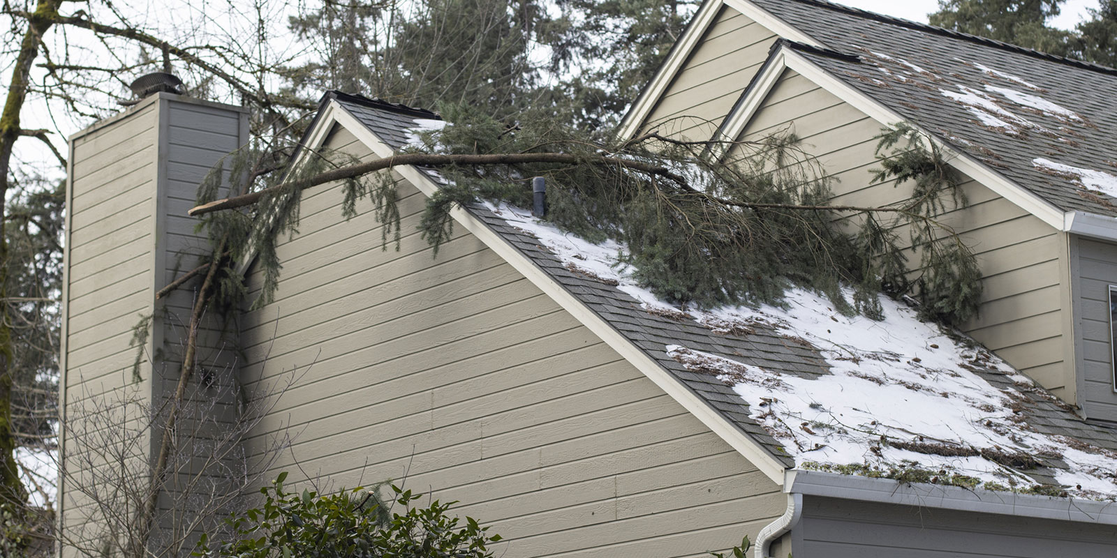 Crew installing emergency roof tarping during storm response roofing