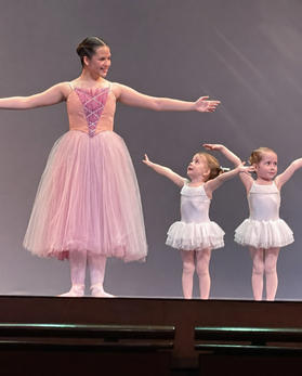 Preschoolers reaching upward joyfully in a creative movement class